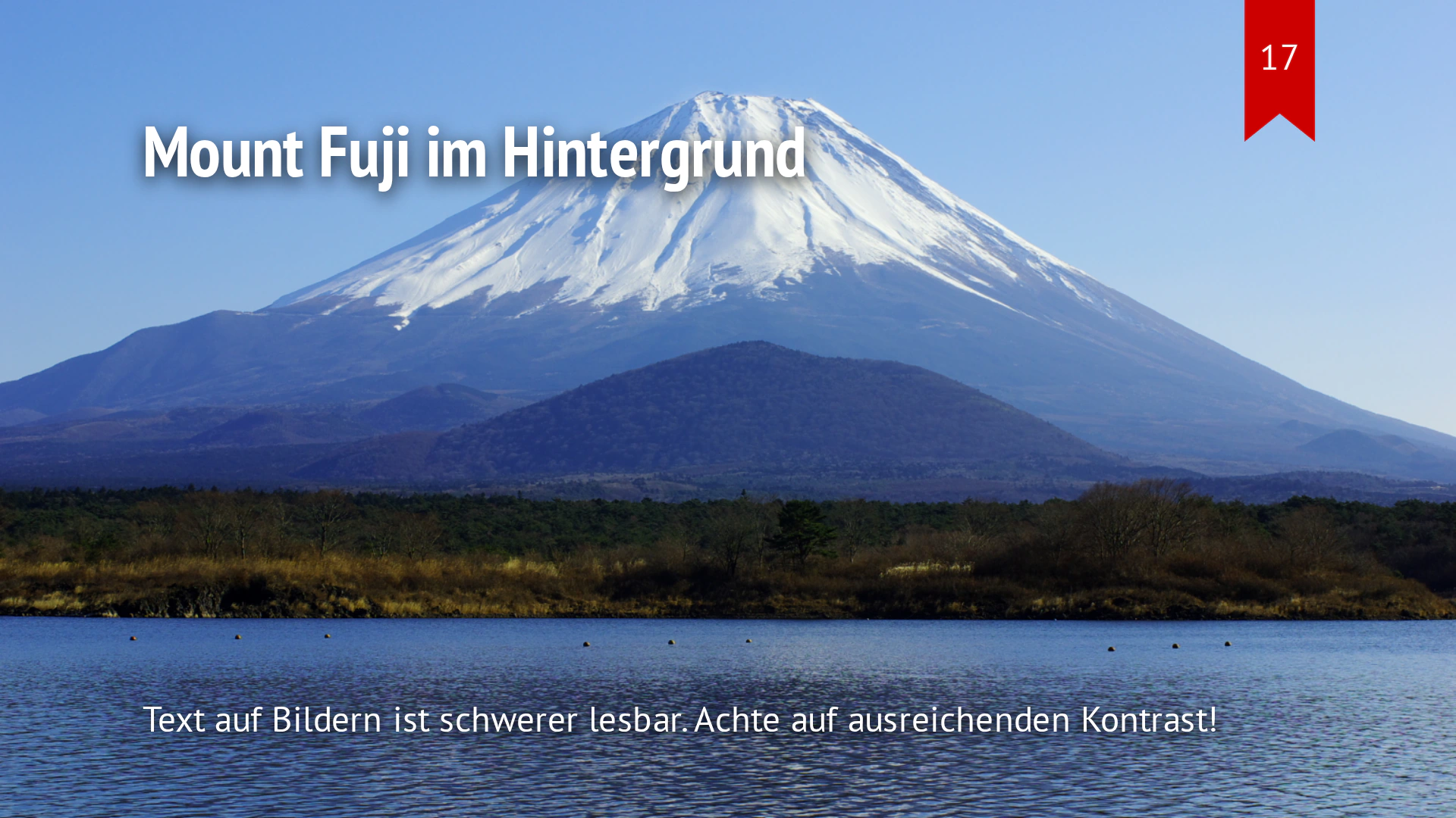 Das Fuji-Foto füllt die gesamte Folie als Hintergrund; weiße Schrift liegt darüber.